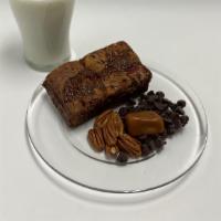 Turtle Brookie · Milk Chocolate Brownie topped with pecan chocolate chip cookie drizzled with caramel.