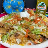 Nacho (Lunch) · Fresh tortilla chips topped with beans, cheese, lettuce, pico de gallo, sour cream, and your...