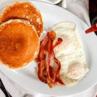 Lumber Jack · Two pancakes, two eggs, choice of bacon, ham or sausage with warm syrup.