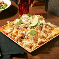 Grindstone Nachos · corn tortilla chips, monterey jack, white queso, bell
peppers, onions, charred corn, queso f...