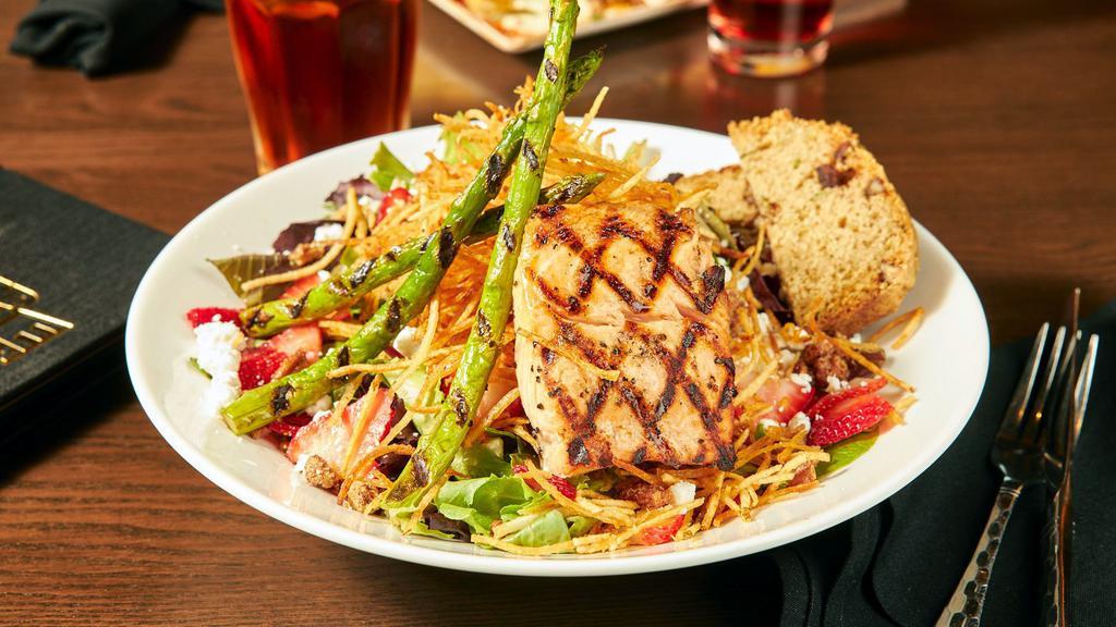 Grilled Salmon Salad · Spring mix, balsamic vinaigrette, sliced strawberries, candied pecans, goat cheese crumbles, grilled salmon, asparagus, crispy potato straws, zucchini nut bread.