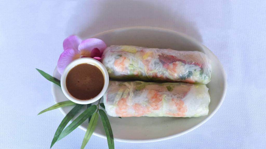 Spring Rolls (2) · Fresh rolls of rice noodles, shrimp, pork, cilantro, mint, and carrot, served with peanut sauce.
