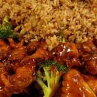 General Tso Chicken · Deep fried chicken coated in sweet, savory sauce, & garnished with broccoli crowns.