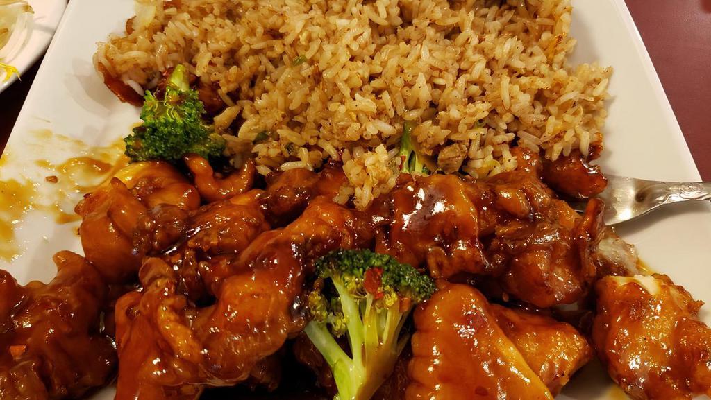 General Tso Chicken · Deep fried chicken coated in sweet, savory sauce, & garnished with broccoli crowns.
