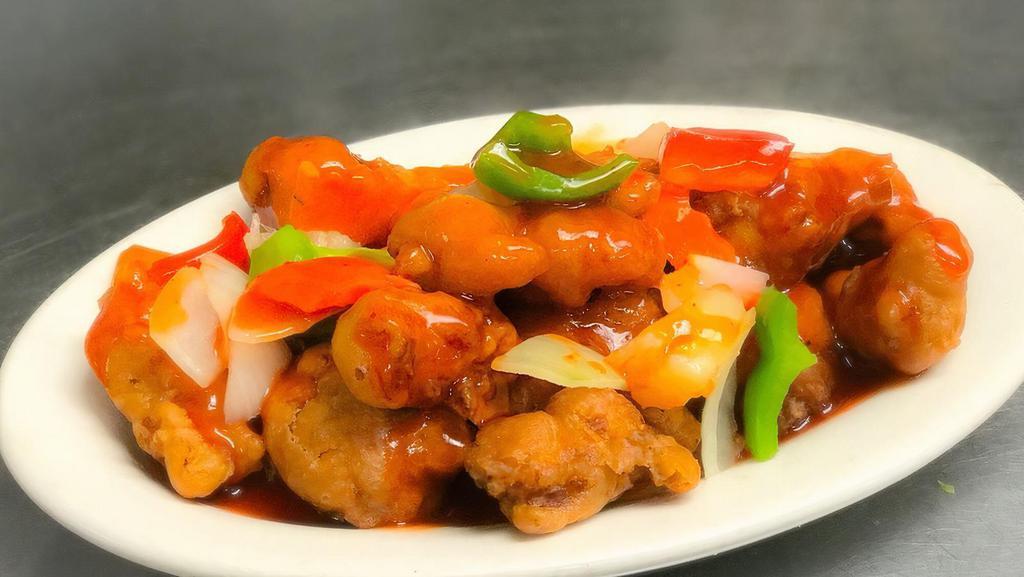 Sweet & Sour Chicken · Classic fried chicken coated in sweet & sour sauce, garnished with sweet bell peppers & pineapple chunks.