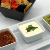 Trio Latino · White queso, fresh guacamole, and house made salsa. Served with tortilla chips.