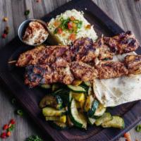 Chicken Kebob Skewers · Lebanese-style marinated chicken skewers. Served with rice, hummus, grilled vegetables, and ...