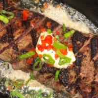 Ny Strip* · 12oz New York strip steak served on a sizzling skillet with coriander butter. Served with ch...