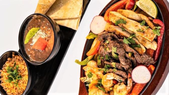Fajitas · Serves up to 2 people. All fajitas are cooked with grilled onion, bell peppers, cilantro served with a side of rice, beans, lettuce, cheese, sour cream, pico de gallo . Choice of corn  tortillas.