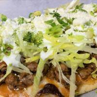 Huarache · Oval shaped disk with Beef steak or spicy chipotle chicken. Topped with beans. lettuce, sour...