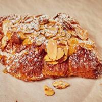 Almond Croissant · Our classic croissant dipped in housemade almond syrup filled with almond cream and topped w...