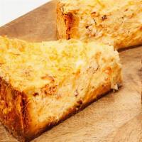 Quiche Lorraine · One slice of quiche - Smoked bacon, caramelized onions & gruyere cheese served with green si...