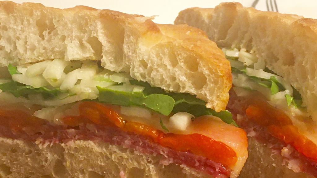 Focaccia Sandwich · Soppressata Salami, Roasted Red Pepper, Swiss cheese, Arugula, Fennel & Celery w/ whole grain mustard.  Served warm