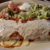 Burrito Grande · 12-inch tortilla stuffed with chicken or beef, rice, beans, sour cream, and guacamole. Toppe...