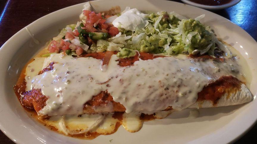 Burrito Grande · 12-inch tortilla stuffed with chicken or beef, rice, beans, sour cream, and guacamole. Topped with cheese sauce and homemade salsa.