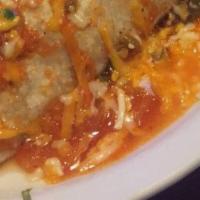 Enchilada Rancheras · Three cheese enchiladas topped with pork, cooked with onions, tomatoes, bell peppers, and en...