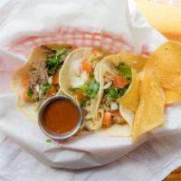 Street Tacos · Three street tacos with cilantro onion and tomato. served with tortilla chips and salsa.