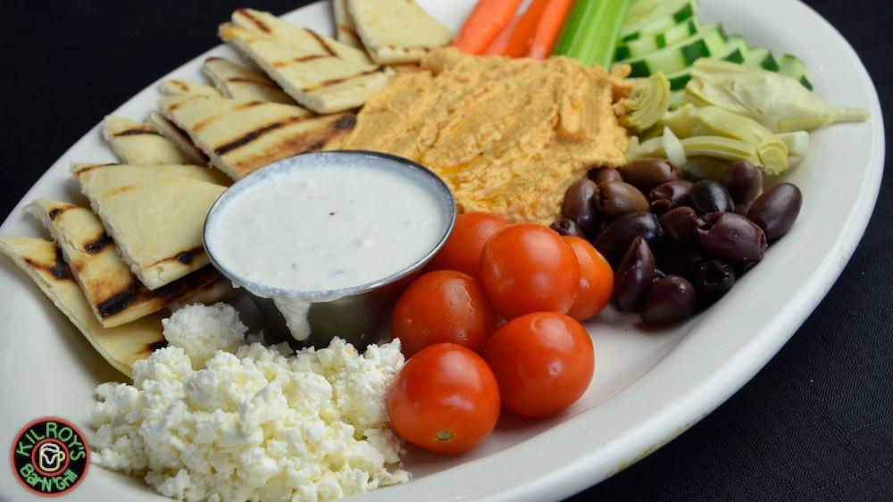 Hummus Appetizer · House-made hummus, topped with olive oil and served with celery, carrots, cucumbers, cherry tomatoes, feta and grilled pita