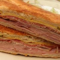 Cuban Sandwich · Pulled pork, honey baked ham, cuban sauce, pickles and swiss cheese. Pressed and grilled to ...