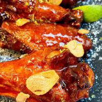 Chinese Garlic Wings · Pluck’d Sweet and Sour Sauce, red pepper flakes and garlic make a delicious glaze for our Ch...