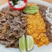 Platillo De Carnitas / Mexican Pork Dish  · Carnitas Pork Served with rice and beans on the side. Comes with 5 tortillas and hot sauce o...