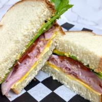 Classic Ham & American · Black Forest Ham, American cheese, yellow mustard, lettuce, tomato, mayo, on white bread.
