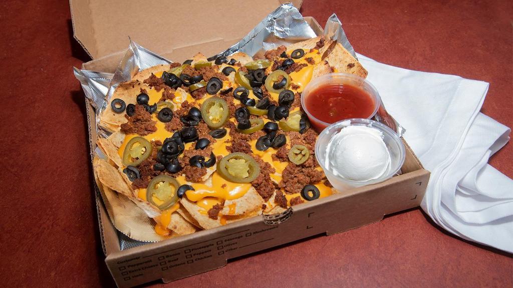 Nachos · Tortilla chips topped with seasoned ground beef, nacho cheese, jalapeno peppers and black olives. Salsa and sour cream served on the side.