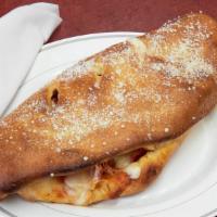 Loaded Pizza Calzone · Oven baked calzone stuffed with pepperoni, ham, pizza sauce, and mozzerella cheese