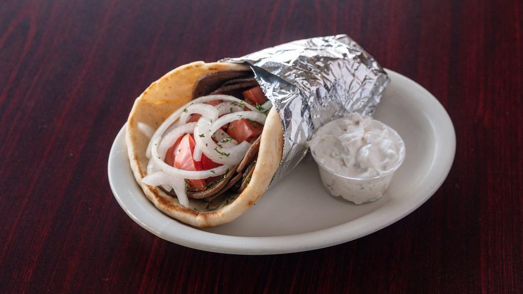 Gyros Sandwich · Thinly sliced gyro meat on pita bread with tomato and onion served with a side of cucumber sauce.