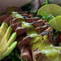 Chimichurri Steak Salad · House-made chimichurri drizzled over flat iron steak, grilled onion & asparagus, cherry toma...