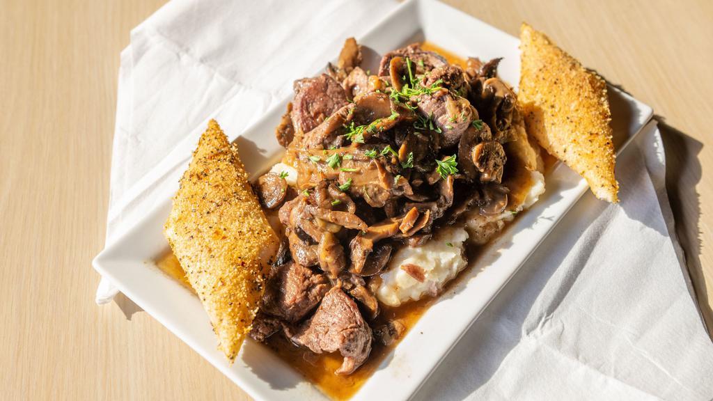 Filet Tips · Angus beef, mushroom onion sauté, over mashed potatoes with classic zip, bread wedges to dip.