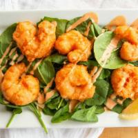 Shakers Bangin' Shrimp · Beer battered & drizzled with Shakers sauce, over baby spinach.