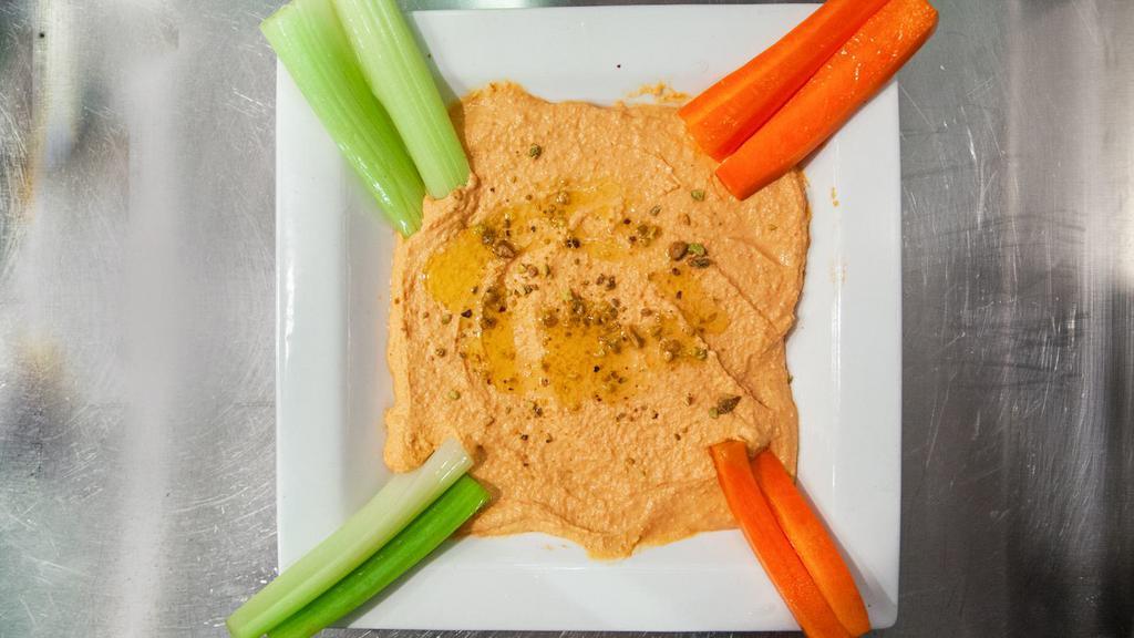 Roasted Red Pepper Hummus · Topped with crushed pistachio, EVOO, served with chips & veggies.