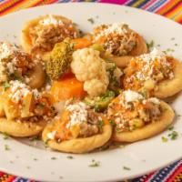 Garnachas · Six small deep fried corn tortillas topped with ground pork, tomato sauce and grated cheese.