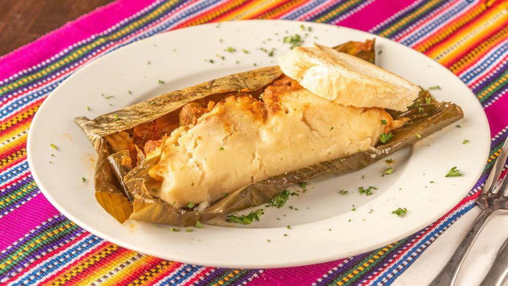 Tamal Guatemalteco Y Salvadoreño Guatemalan & Salvadorian Tamale · Corn tamale stuffed with pork, olives, red peppers steamed in banana leaf served with bread - guatemalan and salvadorian style.