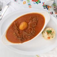 Hilachas · Shredded beef with potatoes simmered in guatemalan creole sauce served with rice.