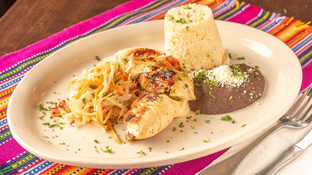Pechuga De Pollo Al Natural · Grilled chicken breast seasoned with lemon and guatemalan spices, served with rice and salad.