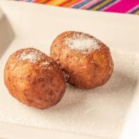 Rellenitos · Made with fried sweet plantain dough stuffed with sweet chocolate and black beans or sweet m...