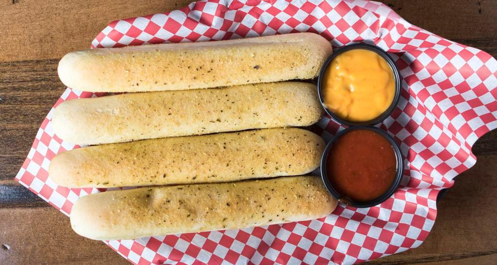 Soft Bread Sticks · Four soft bread sticks seasoned with our special garlic seasoning, topped with romano cheese, served with a side of marinara sauce for dipping.