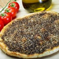 Manaeesh Zaatar (Vegan) · Lebanese round flatbread topped with zaatar (thyme) and toasted sesame seeds