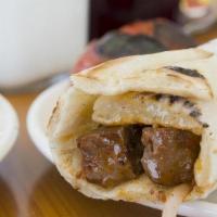 Beef Kabob Sandwich · Beef kabob marinated in a special blend of spices wrapped with pickles, turnips, tomatoes, o...