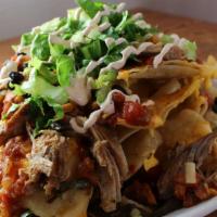 Naughty Nachos · Tortilla chips topped with our melted cheese blend, pico de gallo, Chihuahua cheese, shredde...