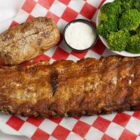 Kansas City Ribs · Baby back pork ribs, dry-rubbed and slow smoked. Served with bbq sauce and coleslaw.