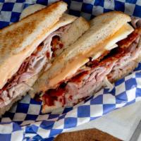 The Elgin Club · Turkey, roast beef, ham, applewood smoked bacon and pepper jack cheese with sriracha mayo on...