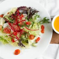 House Salad · Mix of spring greens with sweet carrot ginger dressing.