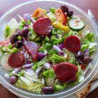 Greek Salad · Crisp greens, beets, onions, tomatoes, cucumbers, green peppers, feta cheese, olives and our...