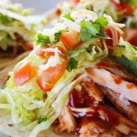 Turkey Tacos · Three Tacos on Corn Tortillas served with Our Famous BBQ Sauce.  Topped with Lettuce, Tomato...