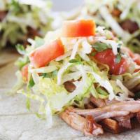 Pork Tacos · Three Tacos on Corn Tortillas served with Our Famous BBQ Sauce.  Topped with Lettuce, Tomato...