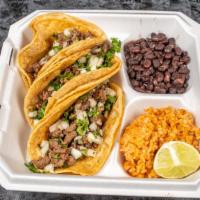 Cena De Taco De Bistec / Steak Taco Dinner · Incluye 3 tacos servidos con arroz, frijoles y ensalada. / Includes 3 tacos served with a si...