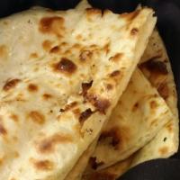 Naan · Flat leavened bread baked on the wall lining of the tandoori oven.